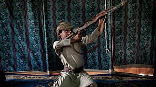 In this July 27, 2018, file photo, Kahlan, a 12-year-old former child soldier with Yemen's Houthi rebels, demonstrates how to use a weapon at a camp for displaced persons