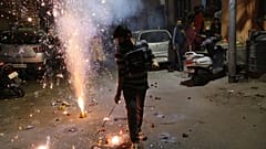 A boy plays with fireworks during Diwali, the Hindu festival of lights, in Jammu, India Saturday, Nov. 14, 2020. 
