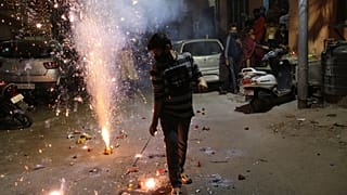 A boy plays with fireworks during Diwali, the Hindu festival of lights, in Jammu, India Saturday, Nov. 14, 2020. 