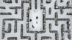 People walk with their dogs in a snow-covered garden maze in Gelsenkirchen, Germany. Extreme winter weather hit the north and west of the country. February 10, 2021