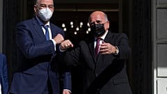 Greek foreign Minister Nikos Dendias, left, welcomes his Iraqi counterpart Fuad Hussein