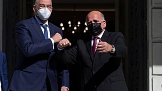 Greek foreign Minister Nikos Dendias, left, welcomes his Iraqi counterpart Fuad Hussein