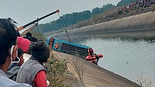 A bus that fell into a canal is pulled out in Sidhi district, in the central Indian state of Madhya Pradesh, Tuesday, Feb. 16, 2021.