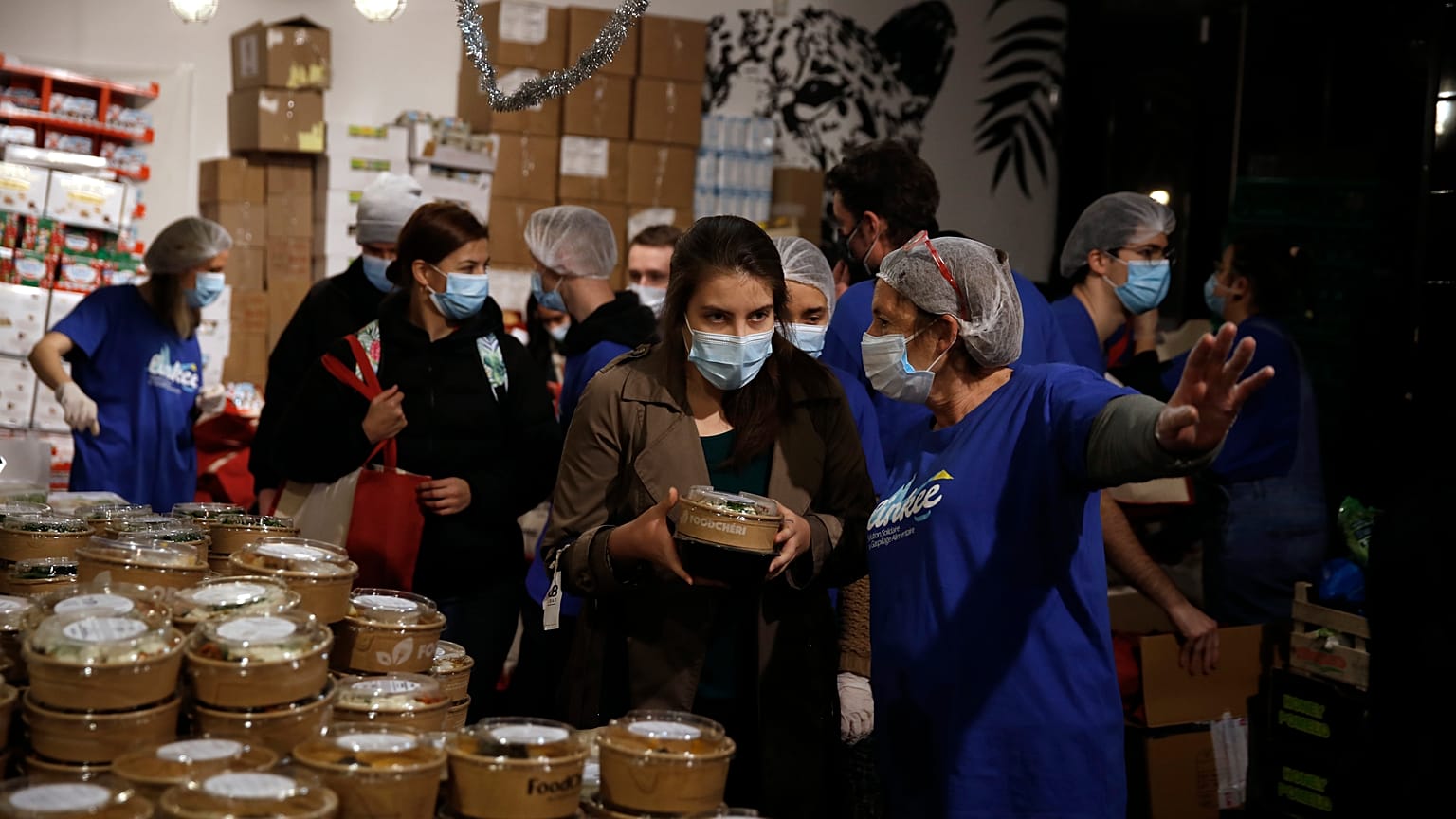 A student gets free food organized by Linkee, a Paris-based company collecting food waste in Paris, Thursday, Feb. 4, 2021. 