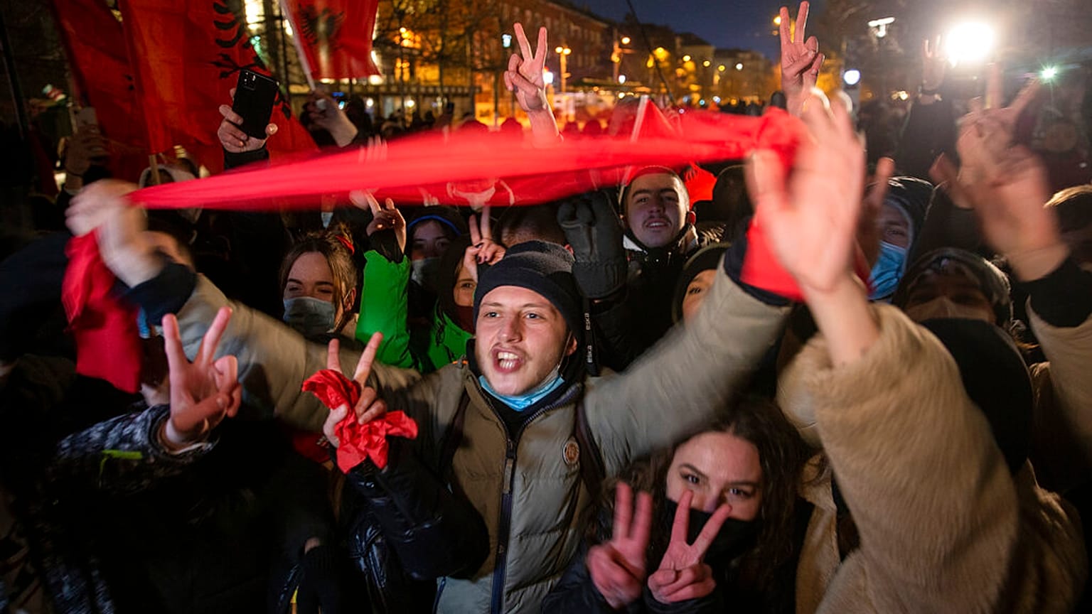 Supporters of the left-wing Self-Determination Movement party react in Pristina, the capitol of Kosovo, on Sunday, Feb. 14, 2021.