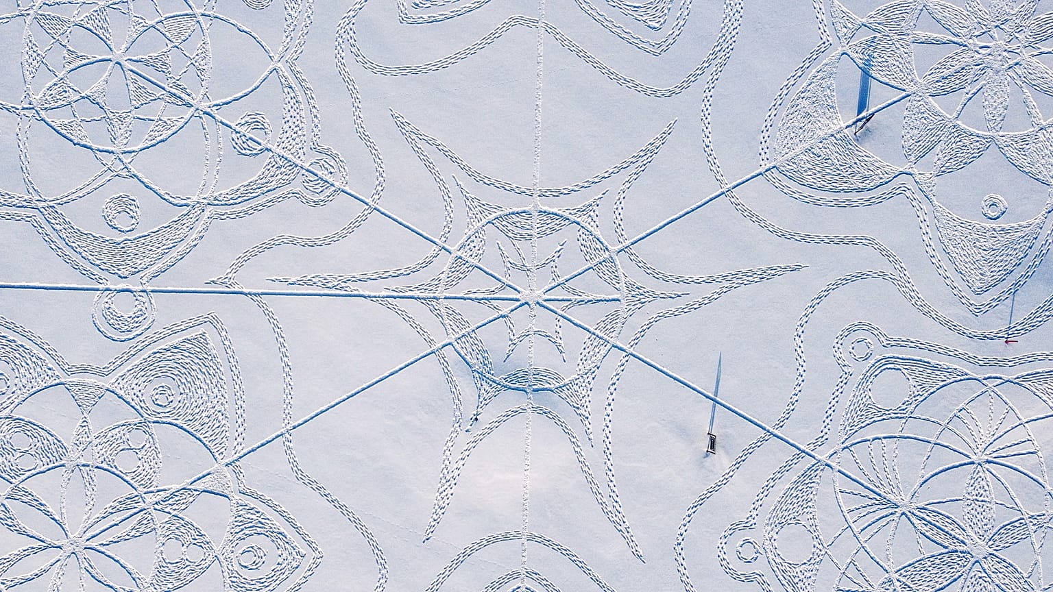 An aerial photograph shows a snow drawing made entirely by footprints