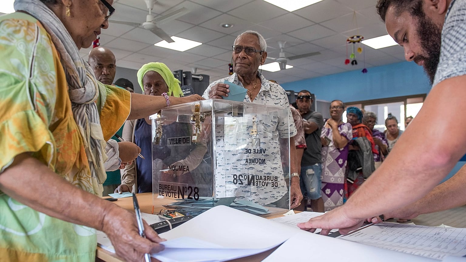A man casts his vote in Noumea, New Caledonia, Sunday, Oct. 4, 2020, during a referendum whether voters choose independence from France.