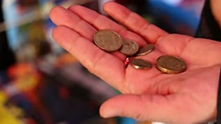 Person paying with pesetas at a news stand in Madrid