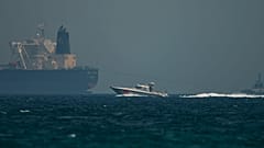 ILLUSTRATION: An Emirati coast guard vessel passes an oil tanker off the coast of Fujairah, United Arab Emirates, May 13, 2019. 