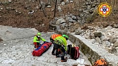 Italy's National Alpine and Speleological Rescue Corps rescue an injured man and his dog on February 18, 2021.