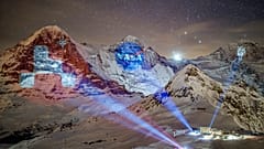 A giant projection of the NASA logos on the Bernese Alps mountains by Swiss light artist Gerry Hofstetter. Mannlichen, Switzerland. February 14, 2021
