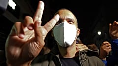 Algerian journalist Khaled Drareni flashes the V sign after being released from prison in Algiers, Friday, Feb.19, 2021.
