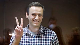 Russian opposition leader Alexei Navalny stands in a cage in the Babuskinsky District Court in Moscow, Russia, Saturday, Feb. 20, 2021.