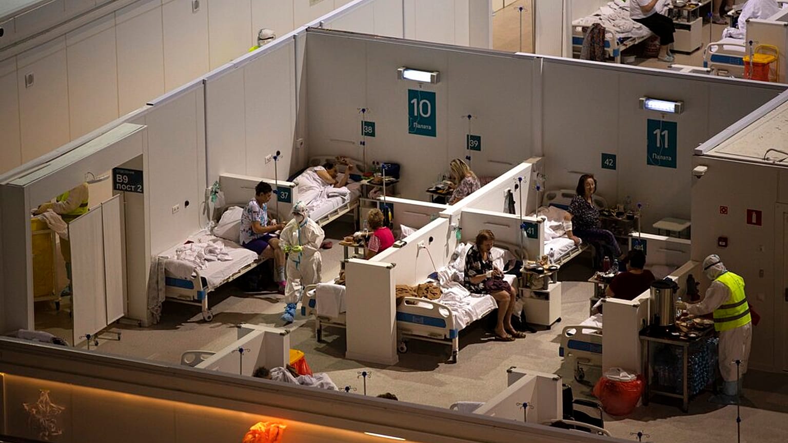 Medical workers and patients in the treatment hall of a temporary hospital for coronavirus patients in the Krylatskoye Ice Palace in Moscow