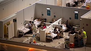 Medical workers and patients in the treatment hall of a temporary hospital for coronavirus patients in the Krylatskoye Ice Palace in Moscow