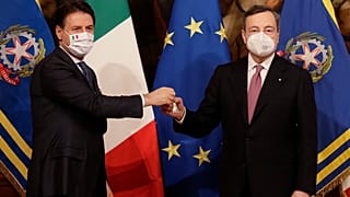Italian outgoing Premier Giuseppe Conte hands over the cabinet minister bell to new Premier Mario Draghi.