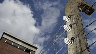 Barbed wire on concrete poles is seen at the memorial site of the former Nazi concentration camp 'Neuengamme'