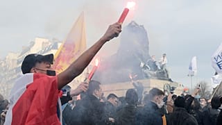 Supporters of the movement Generation Identity light up flares during a demonstration Saturday, Feb. 20, 2021 in Paris