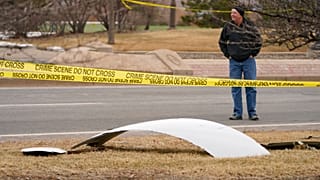 A piece of debris from a commercial airplane is surrounded by police tape on a strip along Midway Boulevard in Broomfield, Colorado. Feb. 20, 2021.