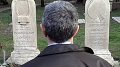 A man stands in front of the graves of English poets Percy Bysshe Shelley and John Keats at a non-Catholic cemetery in Rome, February 2006