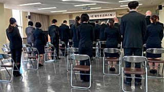 Family members and students attend a memorial ceremony at Toyama Foreign Language College to mourn 12 of their students who died during New Zealand's earthquake 10 years  ago.