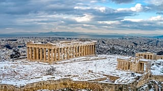 A rare sight of the ancient Acropolis covered in snow in Athens, Wednesday, Feb. 17, 2021