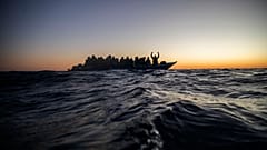 Cooperantes de la ONG española Open Arms se disponen a rescatar a una embarcación abarrotada de personas a 122 millas de la costa libia el 12 de febrero de 2021.