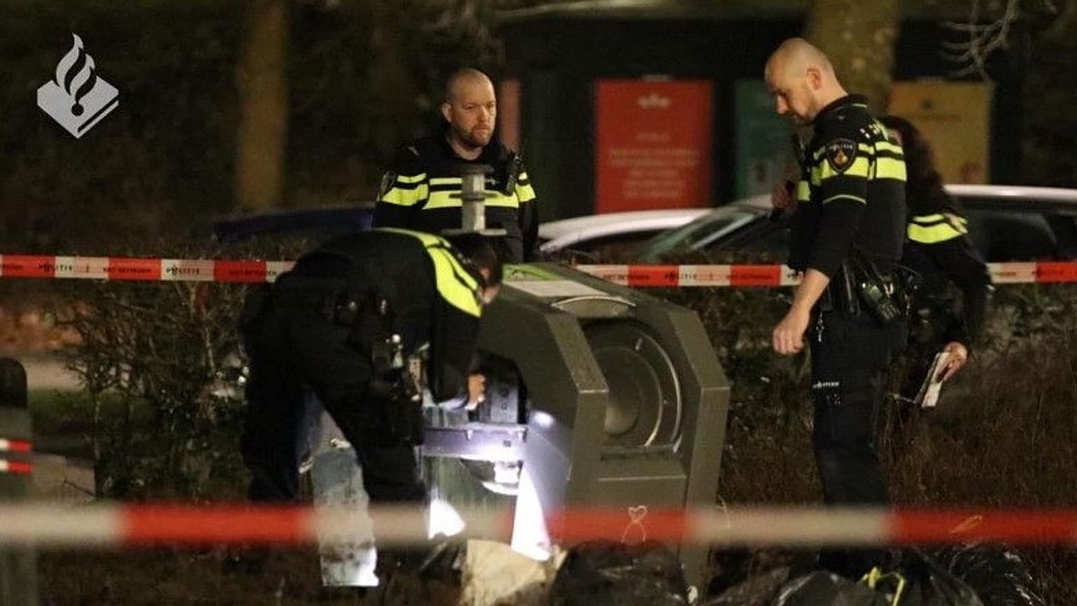 Dutch police inspect the waste container where the baby was found near Amsterdam.