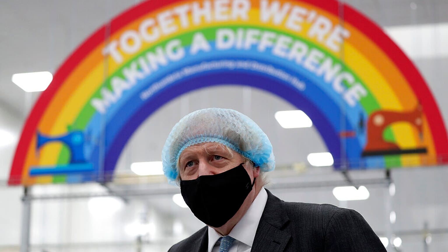 Britain's Prime Minister Boris Johnson, wearing a face mask to prevent the spread of the coronavirus, visits a PPE manufacturing facility in north-east England
