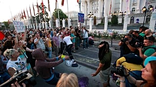 Protestors use an improvised slingshot to throw balloons with colored paint on the Government building during an anti-government protest in Skopje, Macedonia, in 2016.