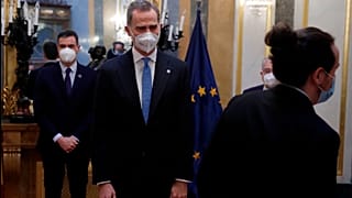 Spain's King Felipe, centre, smiles after greeting Spain's second deputy Prime Minister Pablo Iglesias, right as Spain's Premier Pedro Sanchez, left, looks on. Feb 23 2021