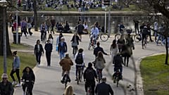 People enjoy the sun in Vondelpark after a sudden change in weather brought spring temperatures around 16 degrees Celsius in Amsterdam, Sunday, Feb. 21, 2021. 