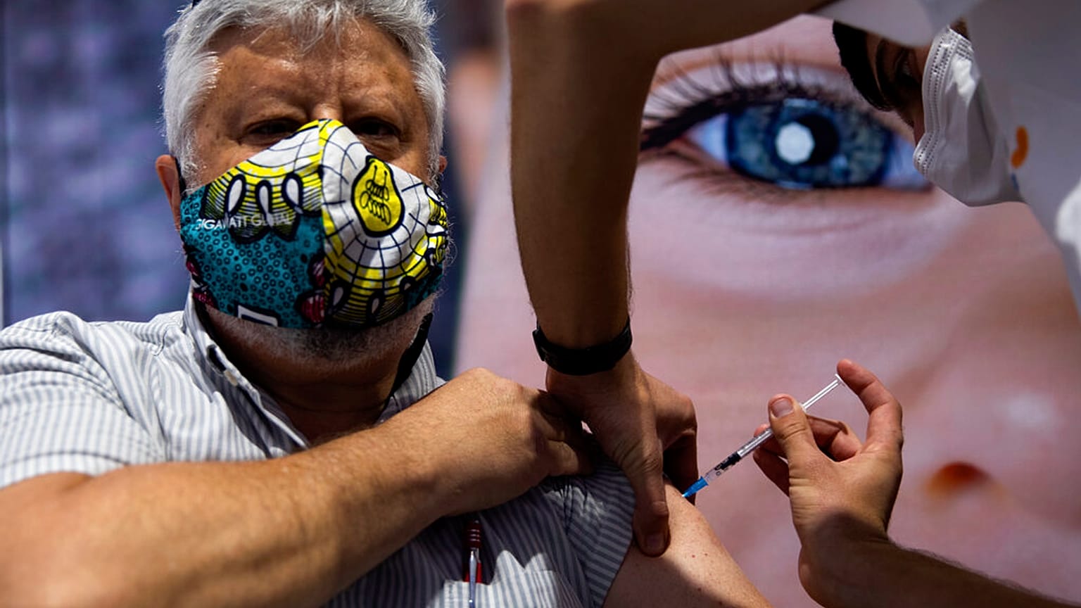 A man receives the second Pfizer-BioNTech COVID-19 vaccine at a vaccination center in Jerusalem, during a nationwide lockdown to curb the spread of the virus