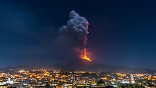 Flames and smoke billowing from a crater of the Mount Etna volcano, Sicily. February 24, 2021