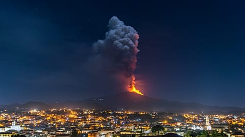 Flames and smoke billowing from a crater of the Mount Etna volcano, Sicily. February 24, 2021