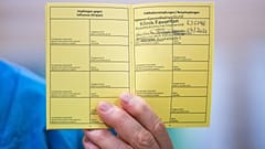 Medical personnel hods a vaccination certificate with a registered Pfizer-Biontech Covid-19 corona virus vaccination at the Favoriten Clinic in Vienna, Austria