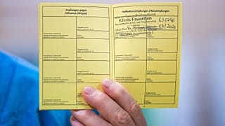 Medical personnel hods a vaccination certificate with a registered Pfizer-Biontech Covid-19 corona virus vaccination at the Favoriten Clinic in Vienna, Austria