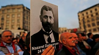 Protesters hold portraits of Armenian intellectuals during a rally to commemorate the anniversary of the 1915 mass killings.