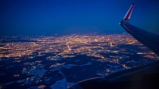 The Illuminated city of Moscow seen through the window of an aircraft coming in to land at Sheremetyevo airport outside Moscow, Russia.