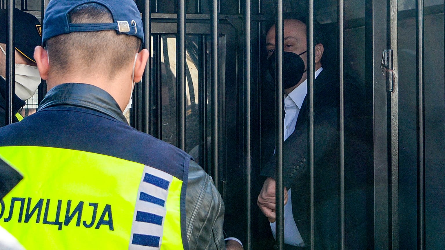 Sasho Mijalkov waits in a police van before he was sentenced at the criminal court.