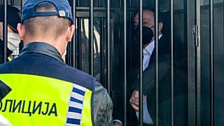 Sasho Mijalkov waits in a police van before he was sentenced at the criminal court.
