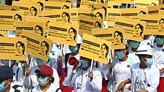Medicals students display images of deposed Myanmar leader Aung San Suu Kyi during a street march in Mandalay, Myanmar, Friday, Feb. 26, 2021.