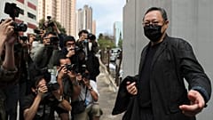 Former law professor Benny Tai, who was arrested under Hong Kong's national security law, walking to a police station in Hong Kong Sunday, Feb. 28, 2021.