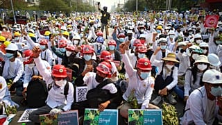Protesters shout slogans during a protest against the military coup in Mandalay, Myanmar, Sunday, Feb. 28, 2021.