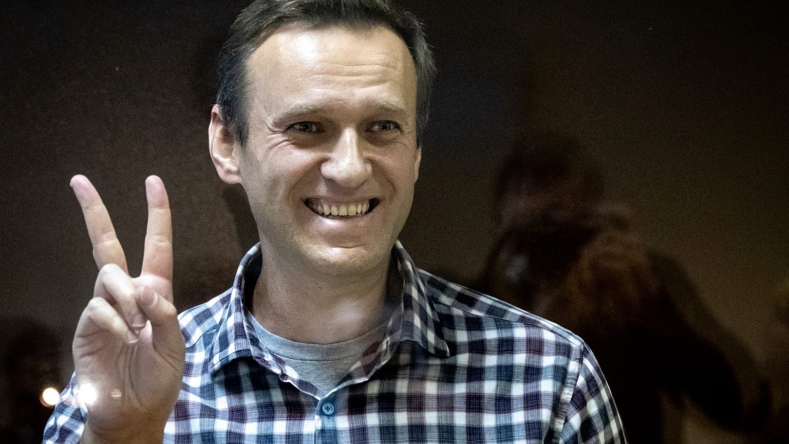 Russian opposition leader Alexei Navalny gestures as he stands behind a grass of the cage in the Babuskinsky District Court in Moscow, Russia on Feb 20, 2021.