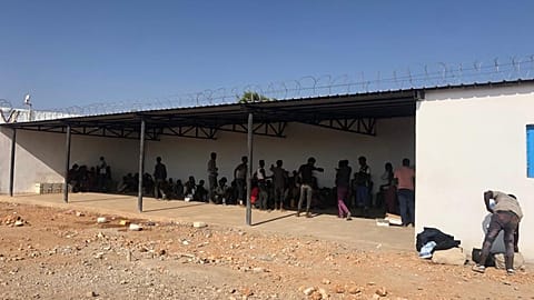 Survivors wait outside the Migrant Response Centre in Obock, Djibouti - IOM