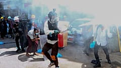 Anti-coup protesters discharge fire extinguishers to counter the impact of the tear gas fired by police during a demonstration in Yangon, Myanmar, March 4, 2021.