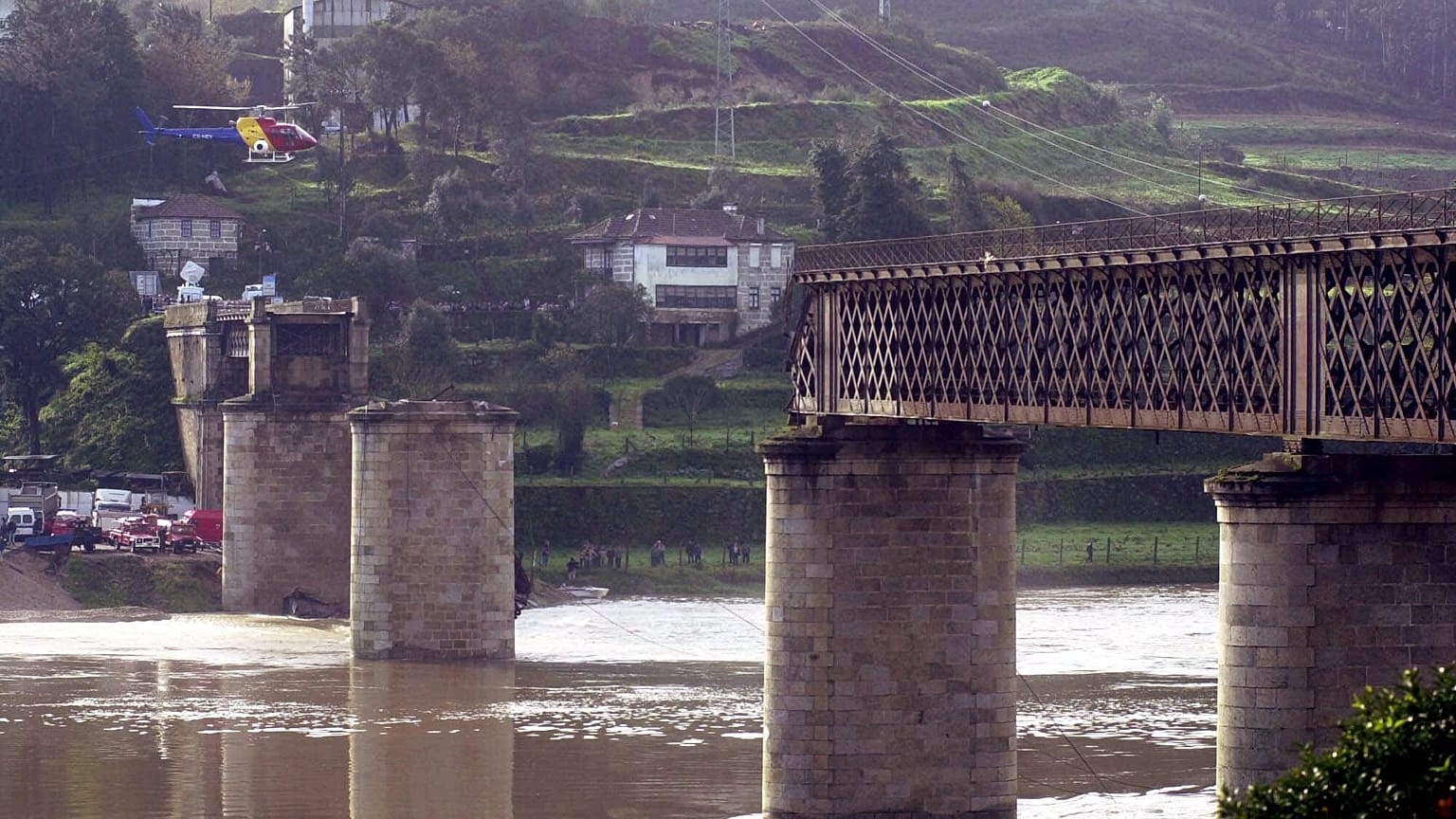 A rescue helicopter circles above the remains of the bridge on March 5, 2001.
