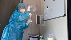 A member of the medical staff of the National Health Organisation (EODY) prepares to conduct a rapid test for COVID-19 