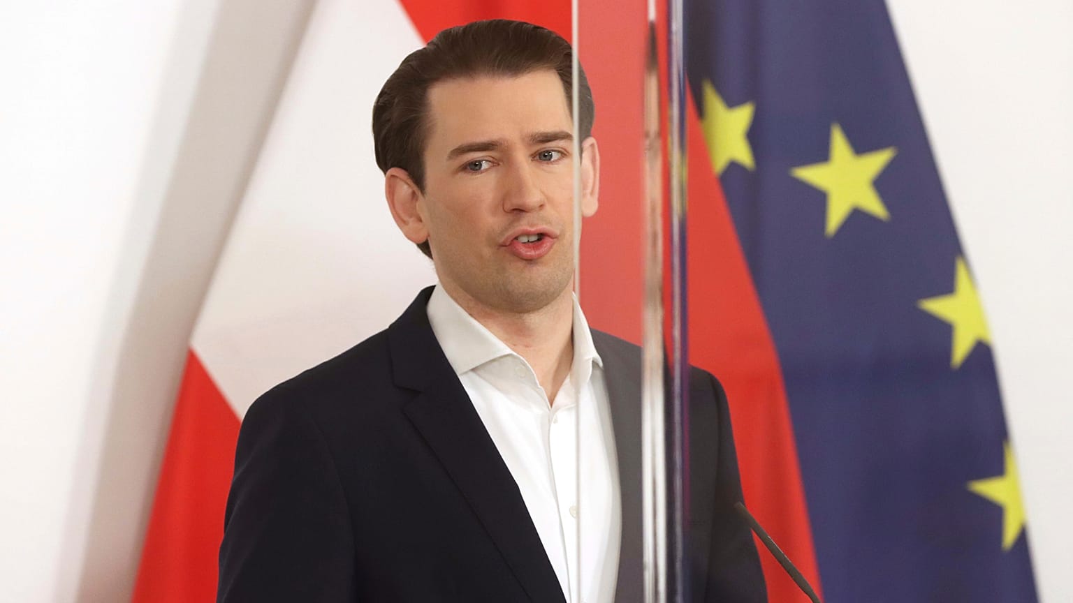 Austrian Chancellor Sebastian Kurz speaks behind plexiglass shields during a press conference at the federal chancellery in Vienna, Austria, Friday, March 5, 2021.